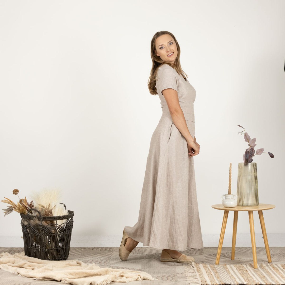 Model in the Linen Wrap Around Dress with Waist Tie, side view capturing the dress's sophisticated style and airy fabric.