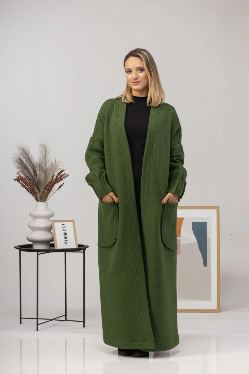 Maxi cardigan with hands in pockets.