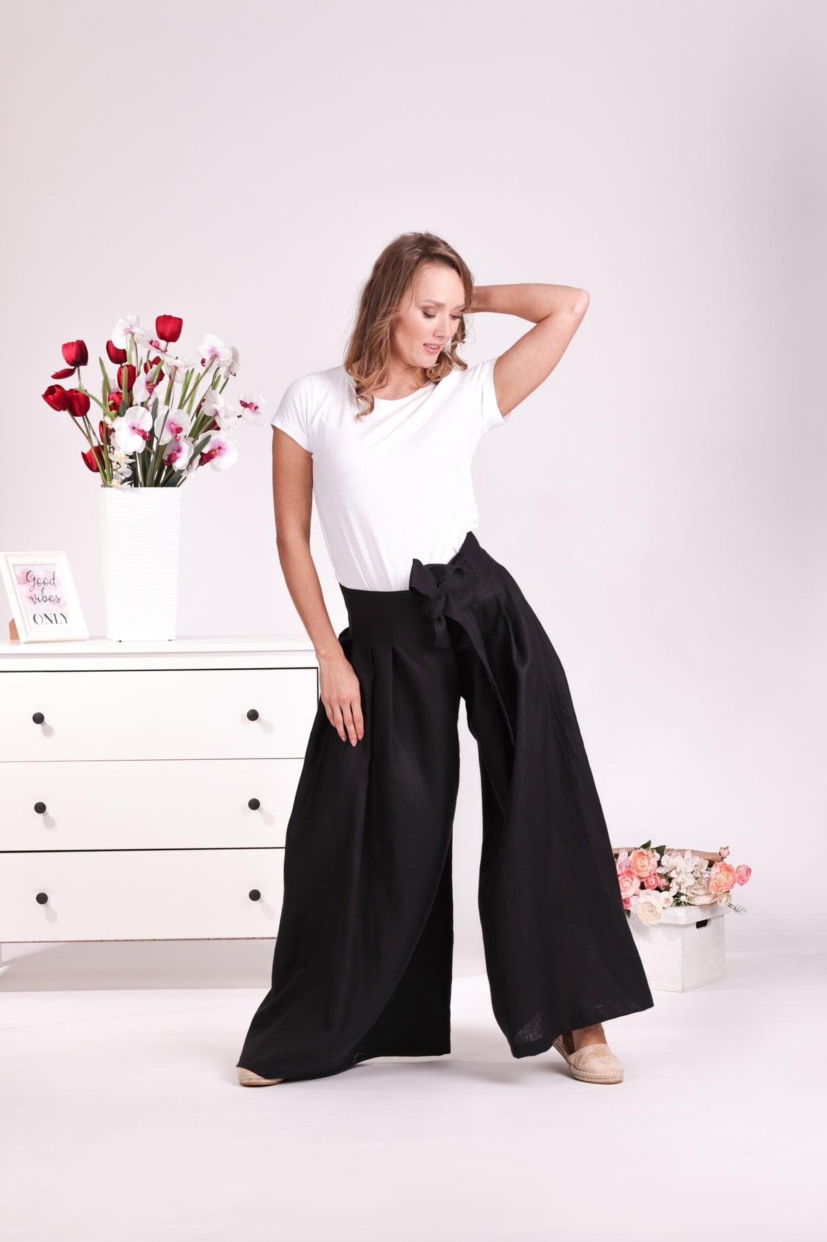 Relaxed black linen trousers with bow detail
