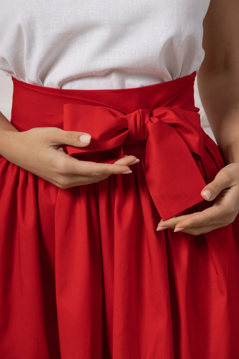 Red skirt with pockets styled with belt

