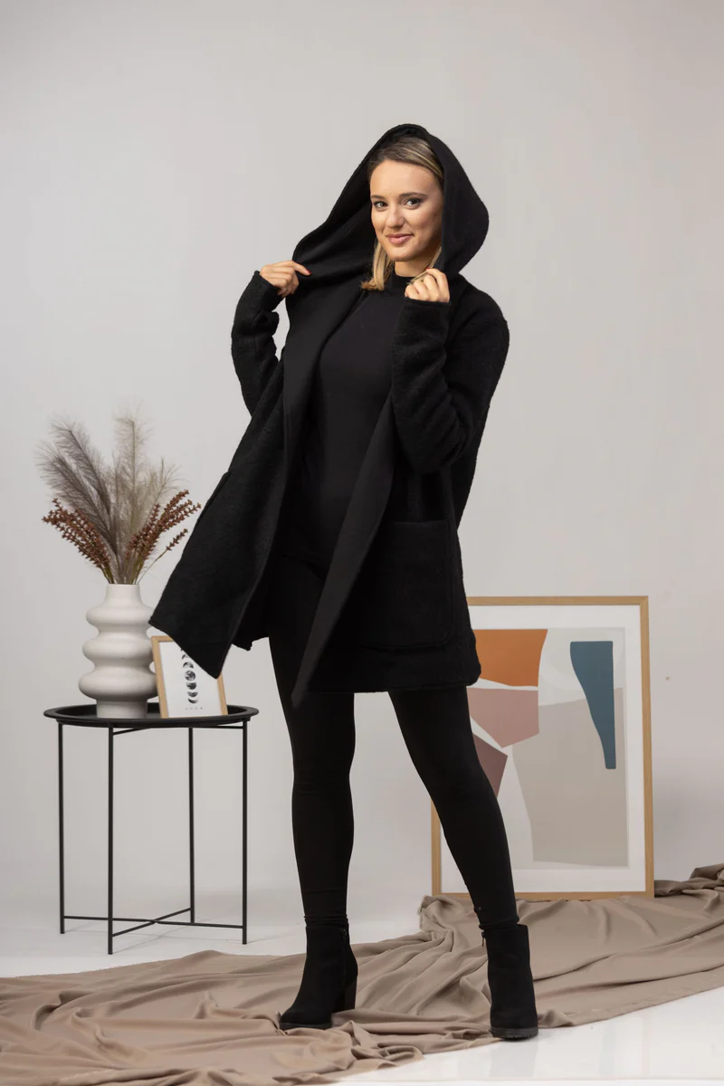 Hooded cardigan over casual outfit.

