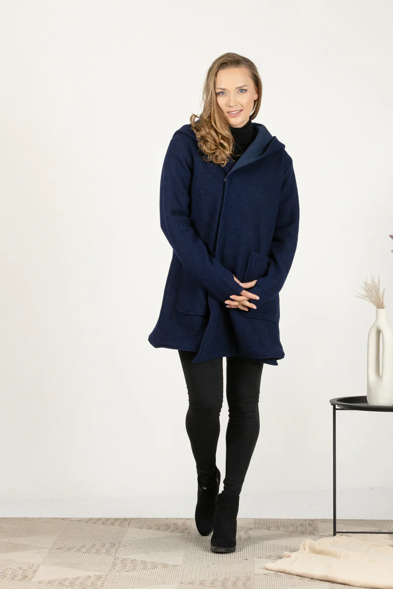 A blue woolen cardigan with a raised hood on the model.
