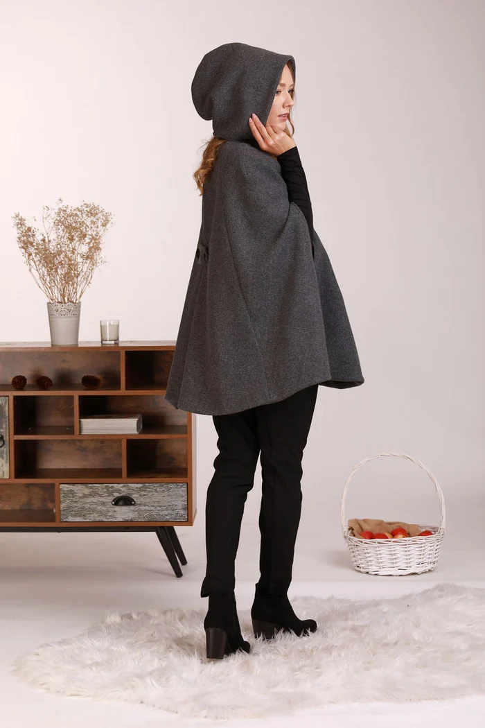 Side view of Hooded wool cape coat with elegant drape


